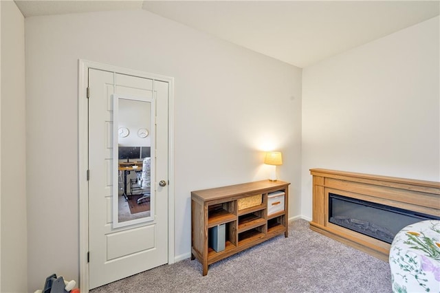 interior space featuring vaulted ceiling and light carpet