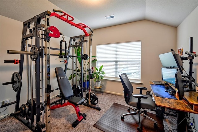 workout room featuring vaulted ceiling and carpet flooring