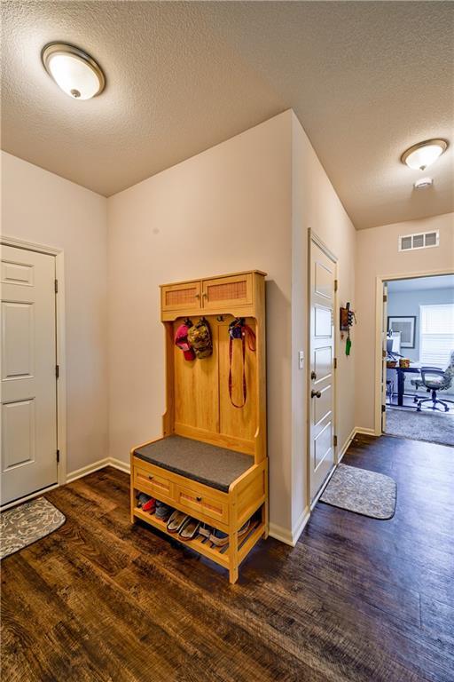 entrance foyer featuring a textured ceiling and dark hardwood / wood-style flooring