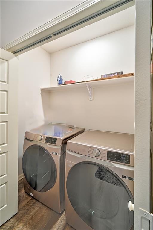 clothes washing area featuring dark hardwood / wood-style flooring and independent washer and dryer