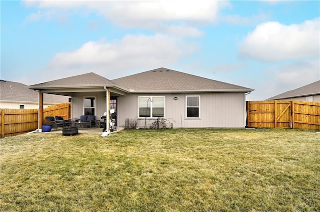 rear view of house with a patio and a lawn