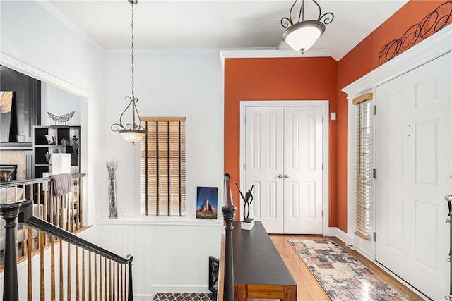 foyer featuring wood-type flooring and a tiled fireplace