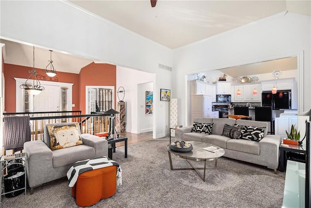 living room with vaulted ceiling and ornamental molding