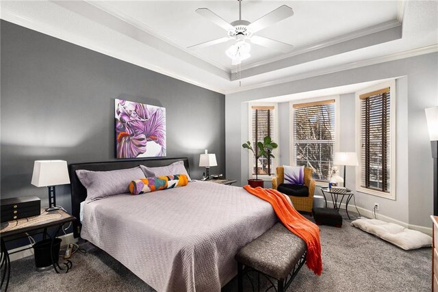 bedroom with crown molding, a raised ceiling, ceiling fan, and carpet flooring