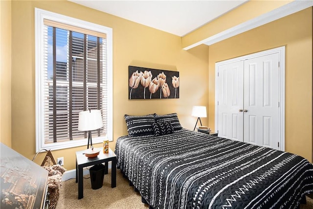 carpeted bedroom featuring a closet