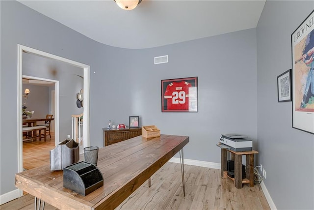 office area with visible vents, light wood-style flooring, and baseboards