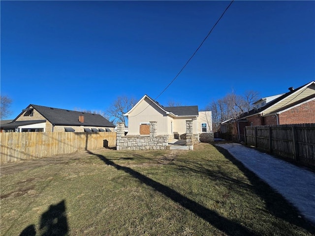 rear view of property with a yard