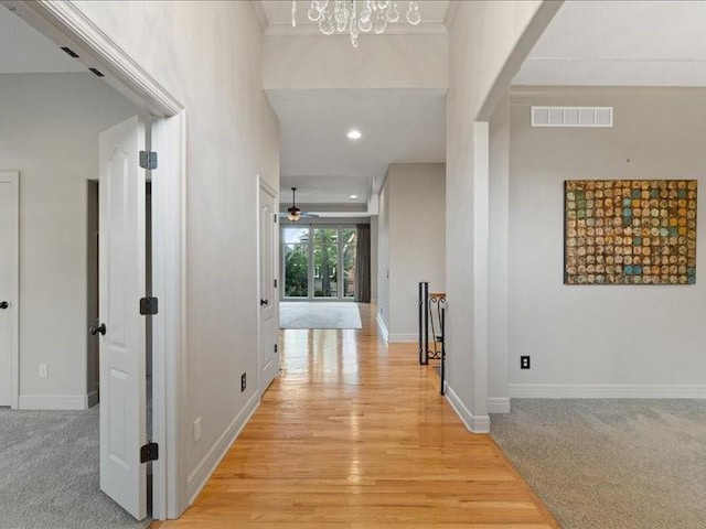 hallway featuring recessed lighting, visible vents, baseboards, and ornamental molding