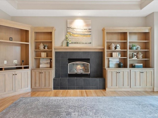 living area with a fireplace and wood finished floors