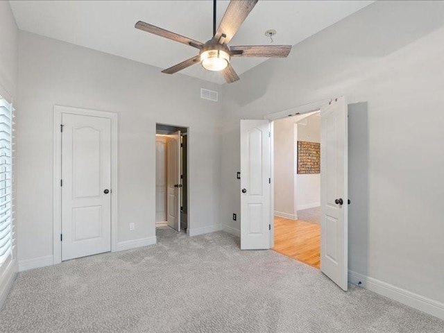 unfurnished bedroom featuring visible vents, light carpet, baseboards, and a ceiling fan