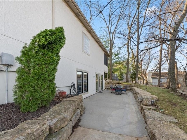 view of home's exterior with a patio area and stucco siding