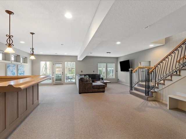 living room featuring baseboards, stairs, light carpet, recessed lighting, and a textured ceiling