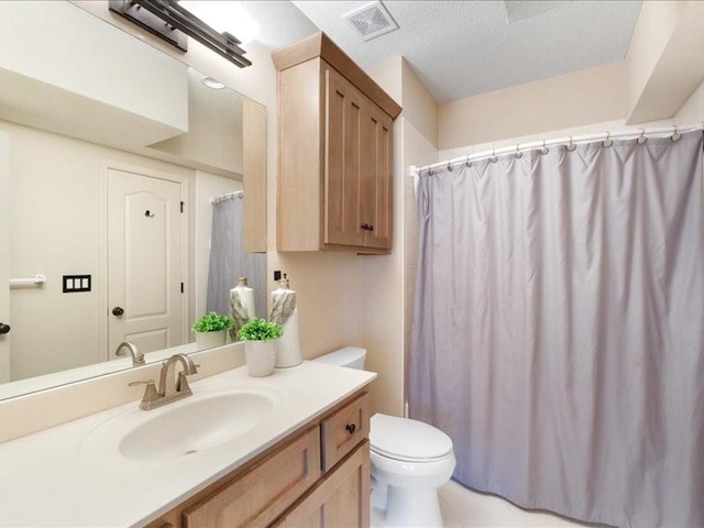 bathroom with vanity, a shower with shower curtain, visible vents, a textured ceiling, and toilet