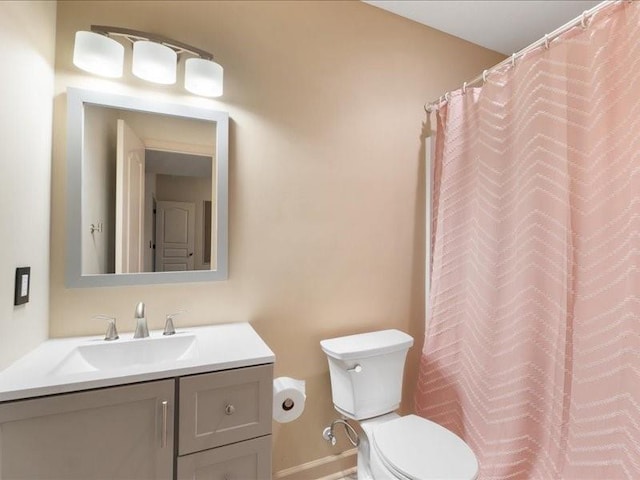 full bath featuring vanity and toilet