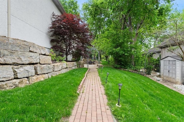 view of grassy yard featuring a shed and an outdoor structure