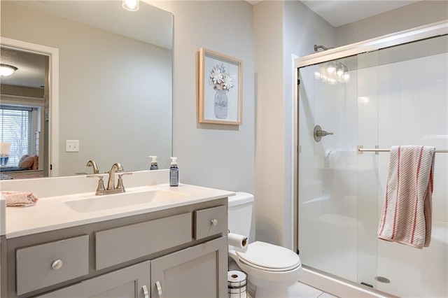 bathroom featuring vanity, toilet, and walk in shower