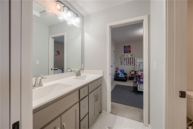 bathroom with vanity and a textured ceiling