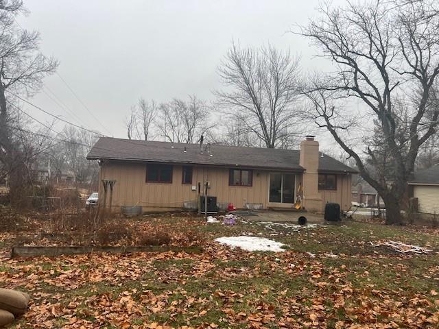 rear view of property featuring cooling unit and a patio area