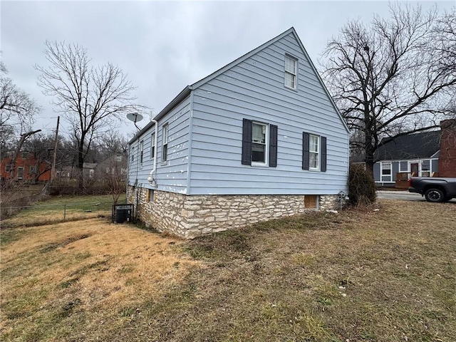 view of home's exterior featuring a yard and central air condition unit