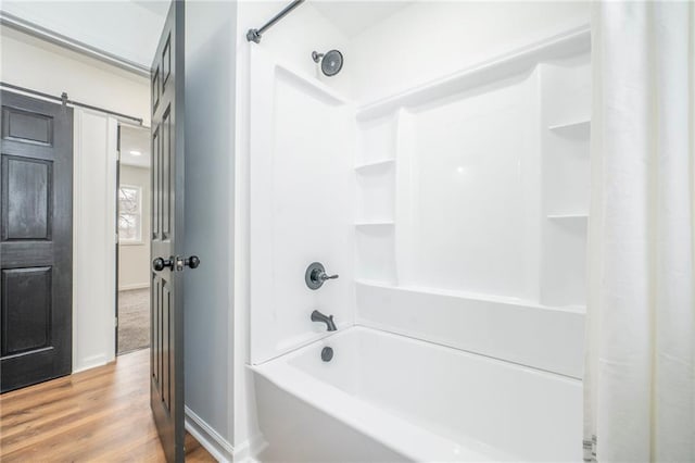 bathroom featuring shower / bath combo with shower curtain and wood-type flooring