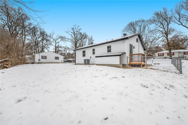 snow covered property featuring cooling unit