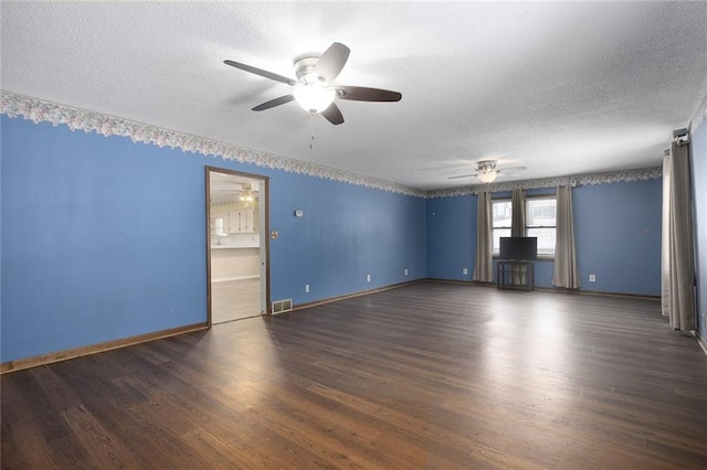 unfurnished room featuring ceiling fan, dark wood-type flooring, and a textured ceiling