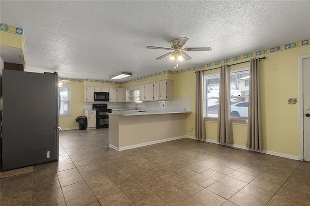 kitchen with sink, ceiling fan, black appliances, decorative backsplash, and kitchen peninsula