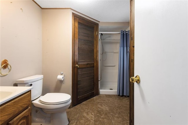 bathroom featuring walk in shower, vanity, and toilet