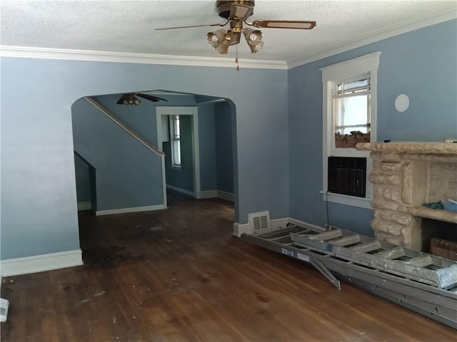 unfurnished living room featuring dark hardwood / wood-style flooring, crown molding, a textured ceiling, and ceiling fan