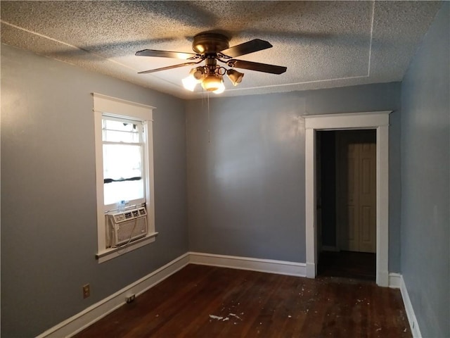 unfurnished room with cooling unit, ceiling fan, dark hardwood / wood-style floors, and a textured ceiling