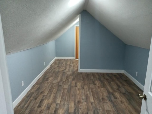 3731 College Ave, Kansas City, MO 64128 - bonus room featuring lofted ceiling and dark hardwood / wood-style floors