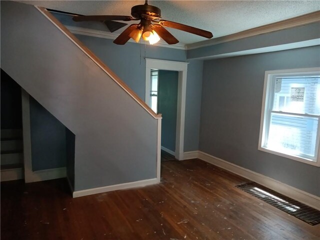 3731 College Ave, Kansas City, MO 64128 - interior space featuring ceiling fan, ornamental molding, dark hardwood / wood-style flooring, and a textured ceiling