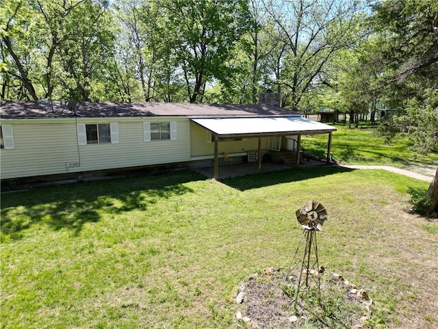 back of property featuring a lawn