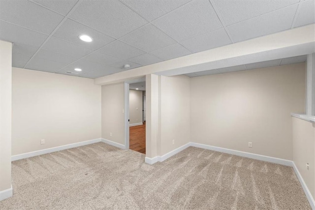 finished below grade area with carpet flooring, recessed lighting, a paneled ceiling, and baseboards