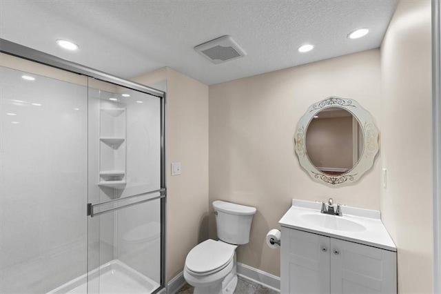 bathroom with visible vents, a shower stall, toilet, vanity, and a textured ceiling