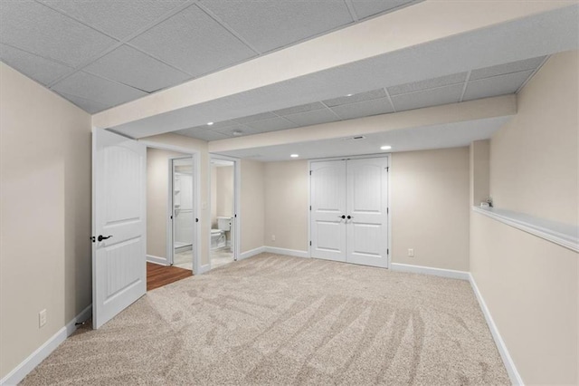 finished below grade area featuring recessed lighting, baseboards, a paneled ceiling, and carpet