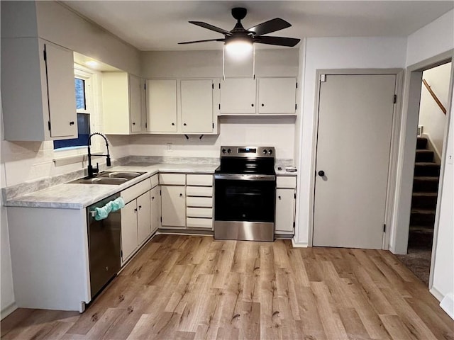 kitchen with sink, ceiling fan, stainless steel appliances, light hardwood / wood-style floors, and white cabinets