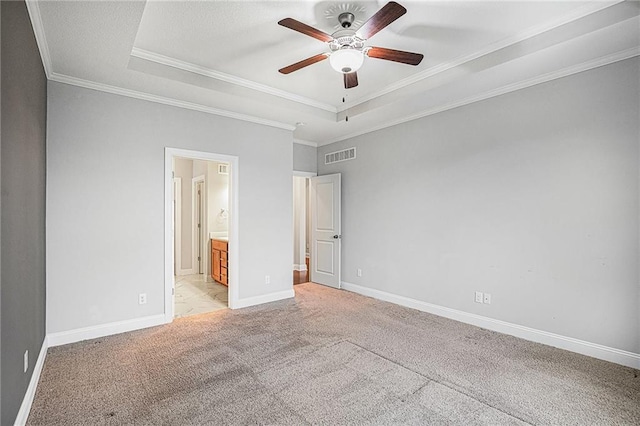 unfurnished bedroom featuring ornamental molding, light colored carpet, and a raised ceiling