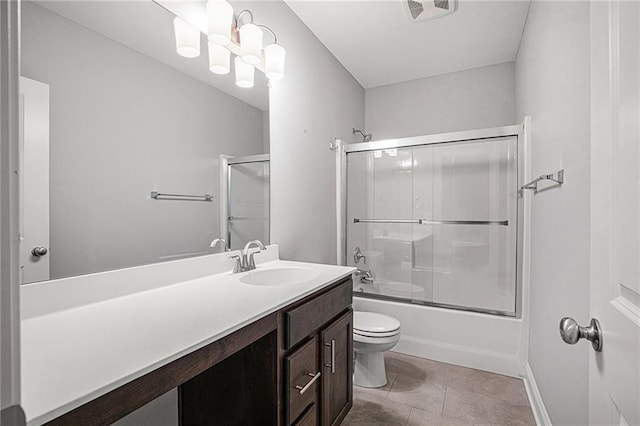 full bathroom with tile patterned flooring, vanity, shower / bath combination with glass door, and toilet