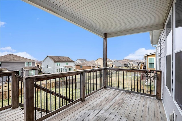 wooden terrace featuring a lawn