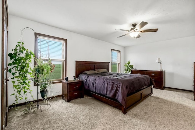 bedroom featuring carpet floors, baseboards, and a ceiling fan