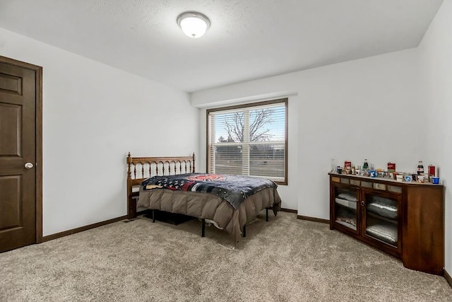 bedroom featuring light carpet and baseboards