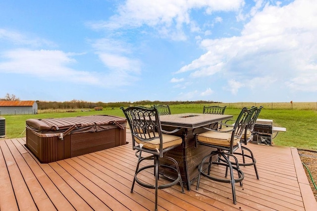 wooden terrace with a hot tub, central AC, and a yard