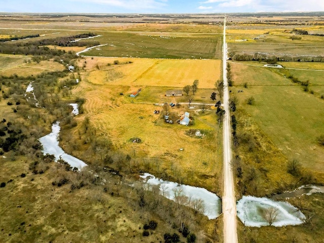 birds eye view of property with a rural view and a water view