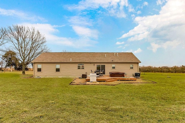 back of house featuring a deck, central air condition unit, a lawn, and a hot tub