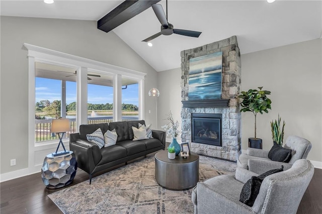 living room with a fireplace, hardwood / wood-style flooring, a wealth of natural light, and vaulted ceiling with beams