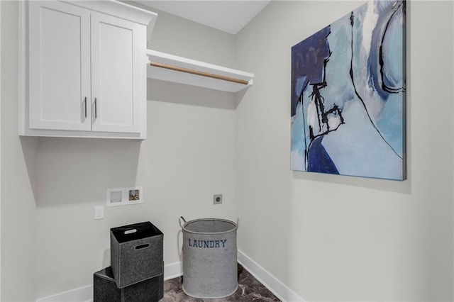 clothes washing area with washer hookup, electric dryer hookup, and cabinets