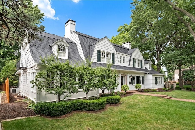 cape cod-style house featuring a front yard and central air condition unit