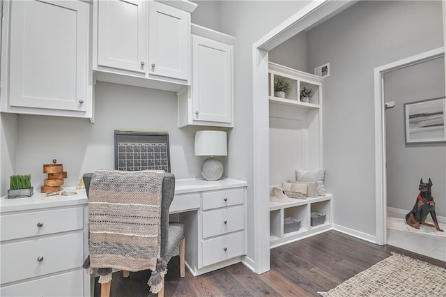 office area with built in desk and dark hardwood / wood-style floors