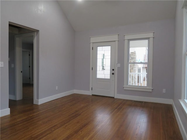 entryway with lofted ceiling and dark wood-type flooring